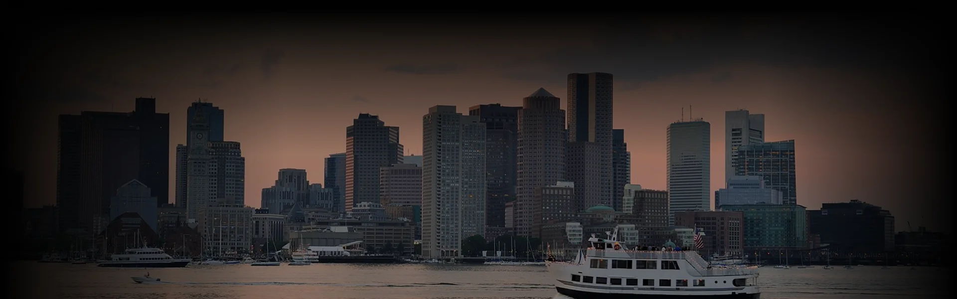Chauffeur in a suit opens the rear door of a black luxury sedan for a well-dressed man holding a leather briefcase, captured from an overhead angle on a cobblestone driveway.